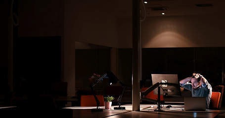 Image showing businessman relaxing at the desk