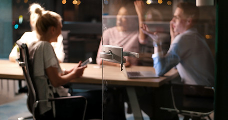 Image showing Multiethnic startup business team in night office