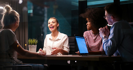 Image showing Multiethnic startup business team in night office