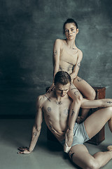 Image showing The young modern ballet dancers posing on gray studio background