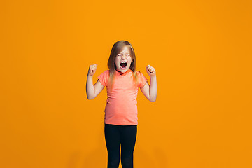 Image showing Isolated on pink young casual teen girl shouting at studio