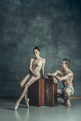 Image showing The young modern ballet dancers posing on gray studio background