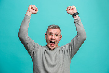 Image showing Winning success man happy ecstatic celebrating being a winner. Dynamic energetic image of male model