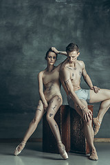 Image showing The young modern ballet dancers posing on gray studio background