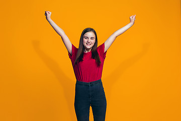 Image showing Happy success teen girl celebrating being a winner. Dynamic energetic image of female model