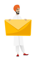 Image showing Smiling businessman holding a big envelope.