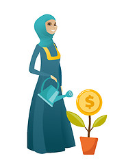 Image showing Muslim business woman watering money flower.