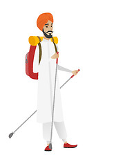 Image showing Hindu man hiker walking with trekking sticks.