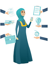Image showing Muslim business woman having lots of work to do.