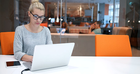 Image showing businesswoman using a laptop in startup office