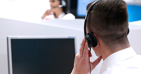 Image showing male call centre operator doing his job