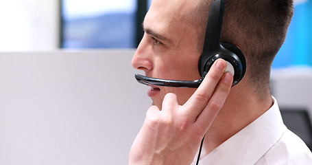 Image showing male call centre operator doing his job