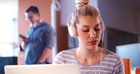 Image showing businesswoman using a laptop in startup office