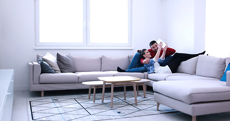 Image showing couple relaxing at  home with tablet computers