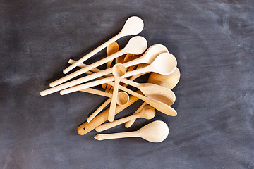 Image showing Wooden spoons on blackboard background.
