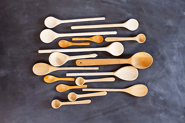 Image showing Wooden spoons on blackboard background. 