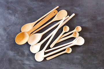 Image showing Wooden spoons on blackboard background.