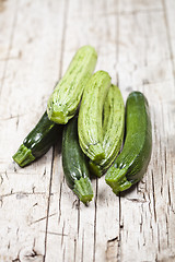 Image showing Fresh green zucchini on wooden rustic table.