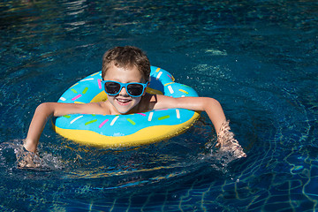 Image showing One little happy boy  playing on the inflatable circle