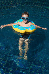 Image showing One little happy boy  playing on the inflatable circle