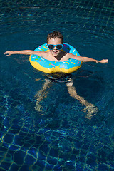 Image showing One little happy boy  playing on the inflatable circle