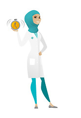 Image showing Muslim doctor holding alarm clock.