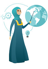 Image showing Muslim business woman pointing at a globe.