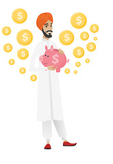 Image showing Hindu businessman holding a piggy bank.