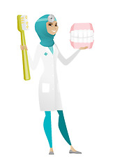 Image showing Dentist with dental jaw model and toothbrush.
