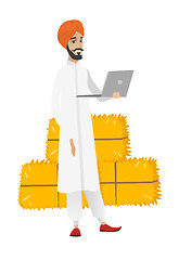 Image showing Hindu farmer using laptop.