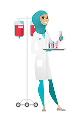 Image showing Laboratory assistant analyzing blood in test tube.