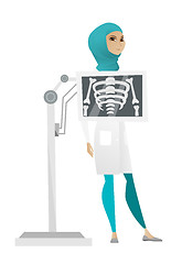 Image showing Muslim roentgenologist during x ray procedure.