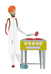 Image showing Traveler man cooking steak on barbecue grill.