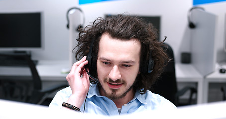 Image showing male call centre operator doing his job