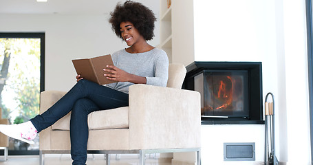 Image showing black woman at home reading book