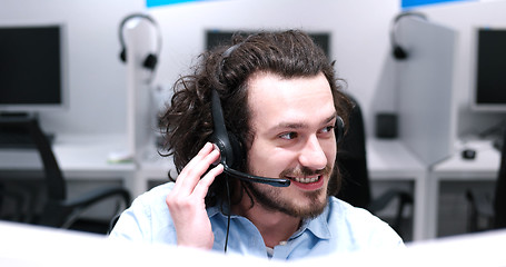 Image showing male call centre operator doing his job