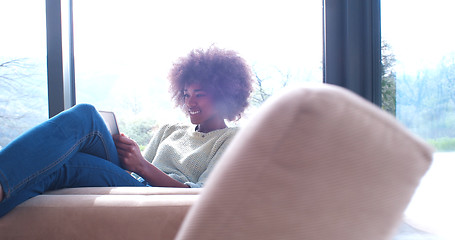 Image showing african american woman at home using digital tablet