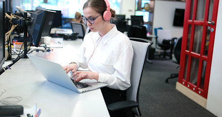 Image showing businesswoman using a laptop in startup office