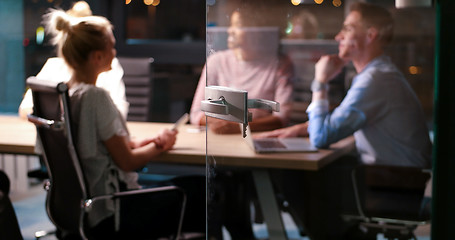 Image showing Multiethnic startup business team in night office