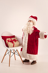 Image showing The happy girl in santa claus costume with gift box at studio