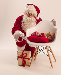 Image showing Christmas portrait of cute little newborn baby girl, dressed in christmas clothes, studio shot, winter time