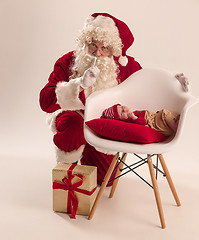 Image showing Christmas portrait of cute little newborn baby girl, dressed in christmas clothes, studio shot, winter time