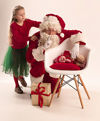 Image showing Christmas portrait of cute little newborn baby girl, dressed in christmas clothes, studio shot, winter time