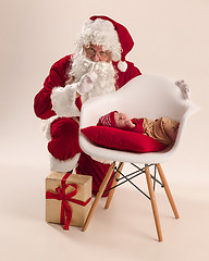 Image showing Christmas portrait of cute little newborn baby girl, dressed in christmas clothes, studio shot, winter time