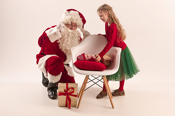 Image showing Christmas portrait of cute little newborn baby girl, dressed in christmas clothes, studio shot, winter time