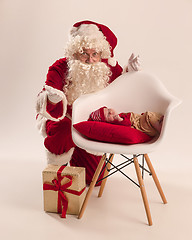 Image showing Christmas portrait of cute little newborn baby girl, dressed in christmas clothes, studio shot, winter time