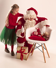 Image showing Christmas portrait of cute little newborn baby girl, dressed in christmas clothes, studio shot, winter time