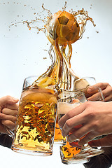 Image showing The many male hands with mugs of beer toasting on studio white background. Sport, fan, bar, pub, celebration, soccer football concept.