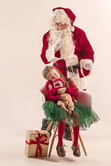 Image showing Christmas portrait of cute little newborn baby girl, dressed in christmas clothes, studio shot, winter time