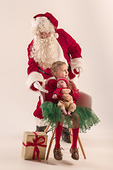 Image showing Christmas portrait of cute little newborn baby girl, dressed in christmas clothes, studio shot, winter time